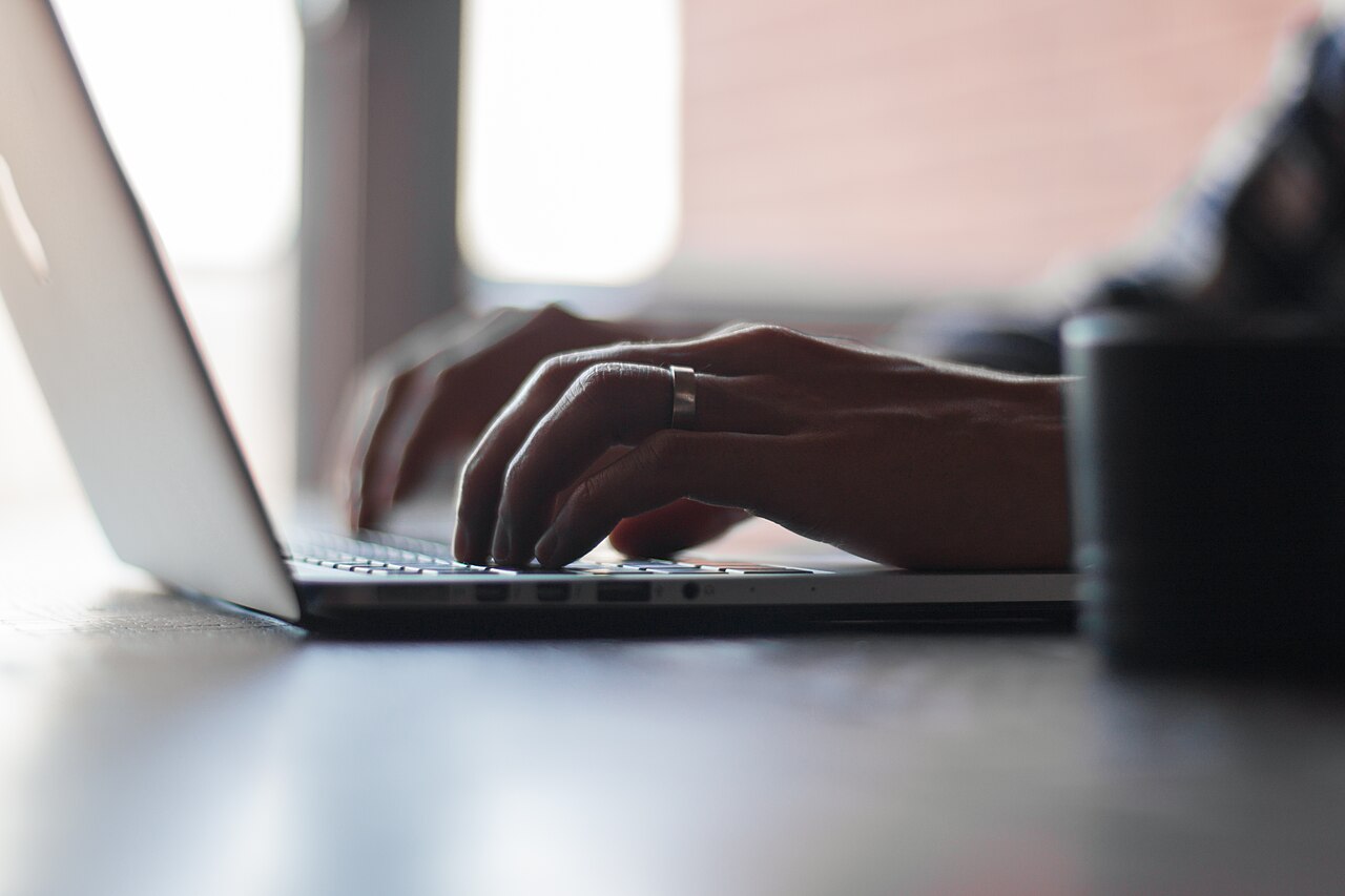 Person coding on a laptop